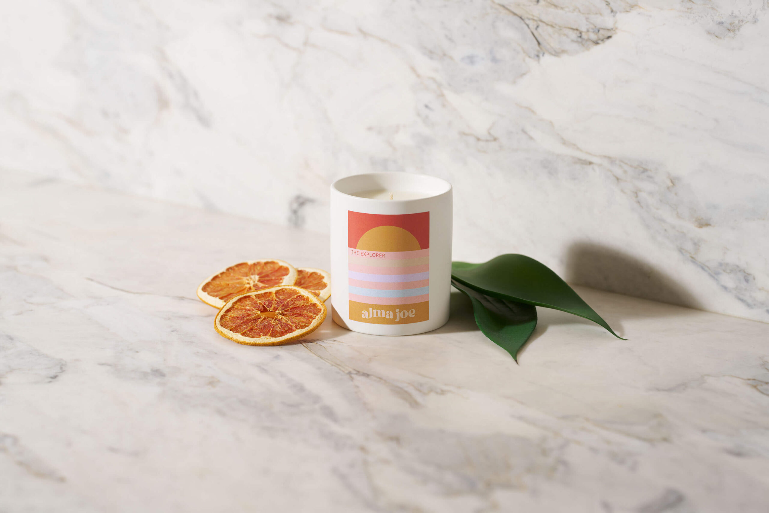 The Explorer candle with citrus and green plant