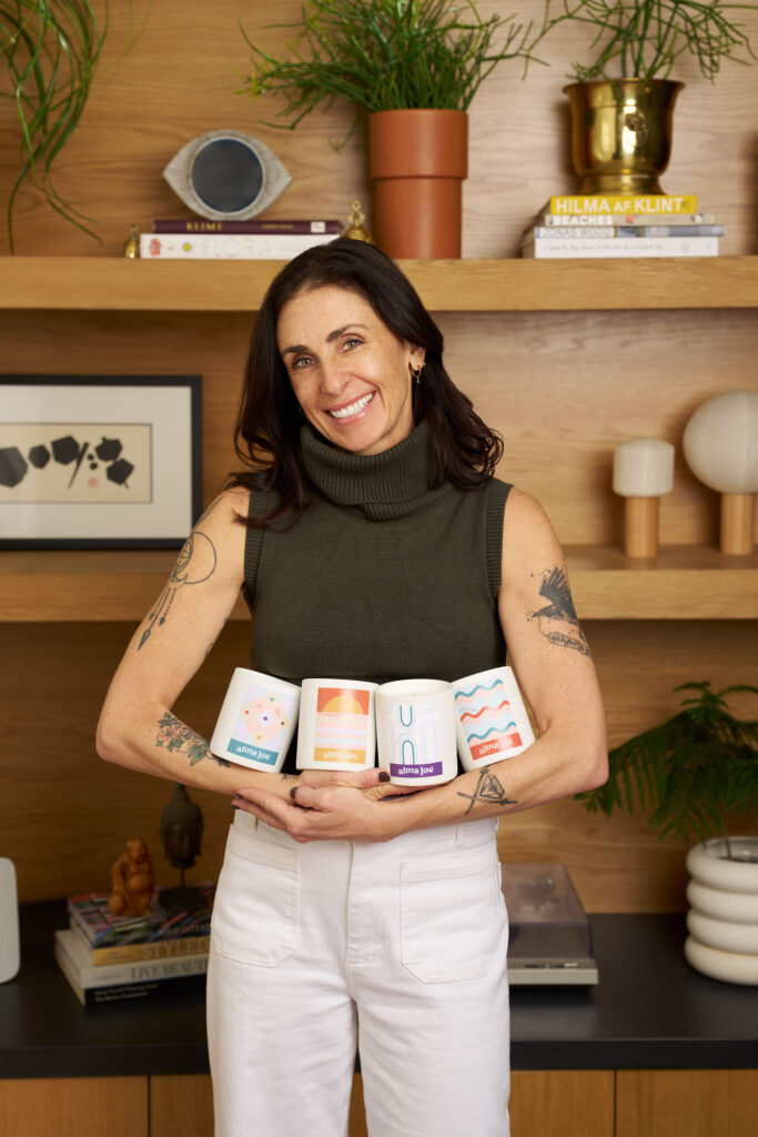 co-founder laura McKowan with candles in her arms