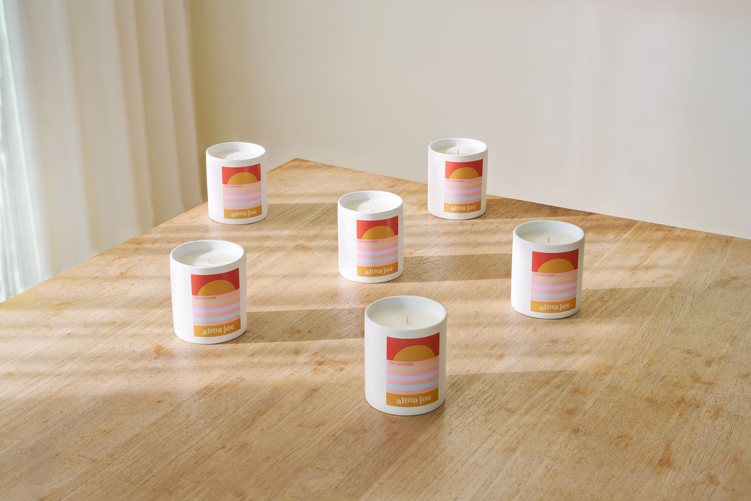 six of the explorer candles on wooden table